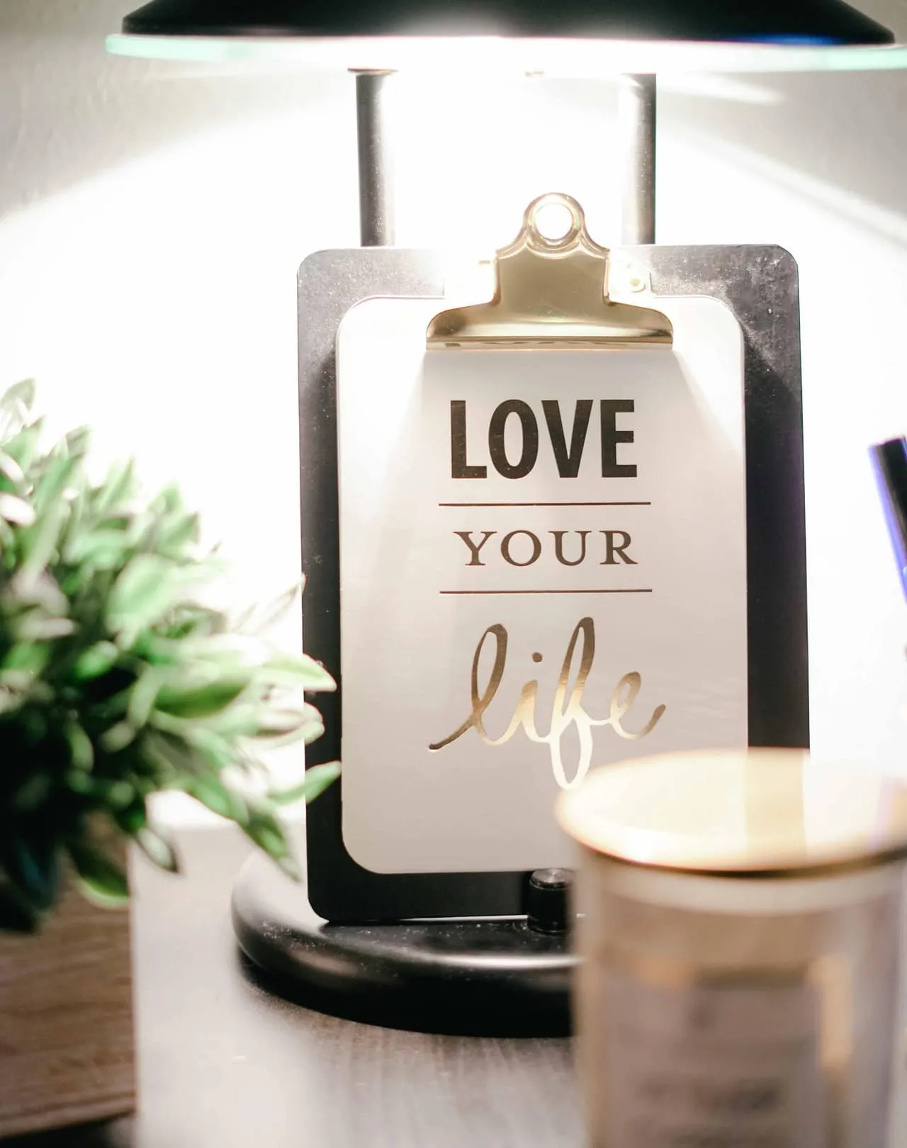 Inspirational clipboard with “Love Your Life” under warm light, symbolizing personal growth and healing through integrative counseling approaches